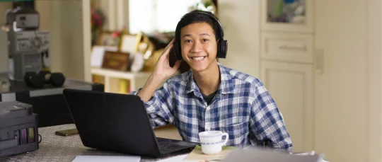 Student wearing a black pair of headphones